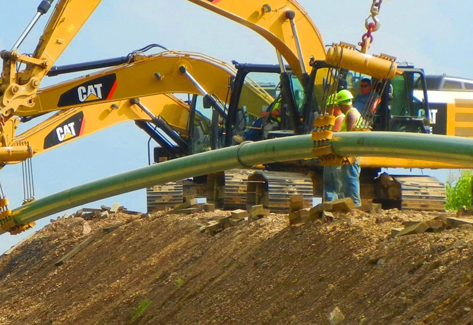 Coworkers work on a gas pipeline job site.